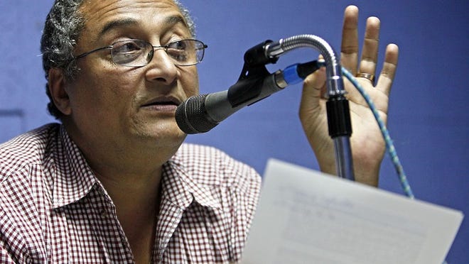 Signal FM journalist Michel Soukar on the air at the radio station in Petionville Saturday.