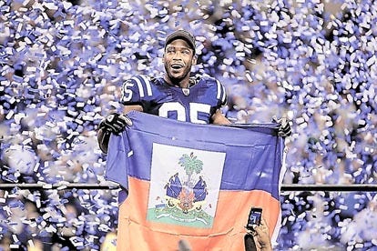 Indianapolis Colts wide receiver Pierre Garcon holds up the Haitian flag after Sunday's game in Indianapolis. AP Photo