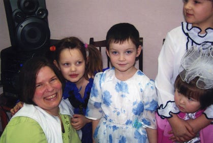 Ann Yorty visits with youngsters at a children’s home in Krasnoyarsk, Siberia, in 2009.