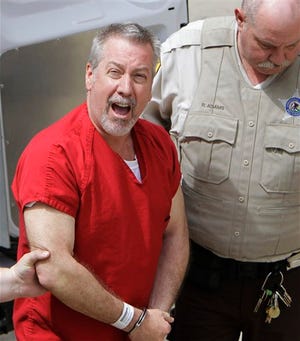 In this May 8, 2009, file photo, former Bolingbrook, Ill., police sergeant Drew Peterson yells to reporters as he arrives at the Will County Courthouse in Joliet, Ill. On Tuesday, Jan. 19, 2010, a judge will hear arguments about the admissibility of the state's new hearsay law to the Peterson's case. He is charged in the death of his third wife, Kathleen Savio, and is also a suspect in the disappearance of his fourth wife. The law would essentially allow Savio to testify from the grave by admitting testimony of family and friends about how she feared Peterson might kill her. (AP Photo/M. Spencer Green, File)