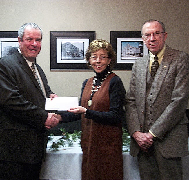Bill Gour and Ed Wine receive a donation on behalf of the Greencastle-Antrim Education Foundation from Waste Management representative Cheryl Shields.