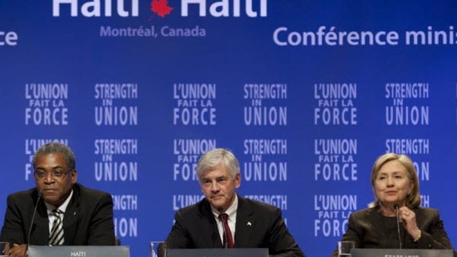 Haitian Prime Minister Jean-Max Bellerive, left, Canadian Foreign Affairs Minister Lawrence Cannon and US Secretary of State Hillary Clinton listen to a question during a news conference following a meeting discussing the future of Haiti