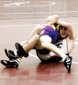 A fight to the finish: Sophomore Jesse Hall tries to get a pin on a Mendota Trojan.