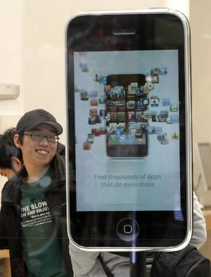 In this Nov. 27, 2009 file photo, a model of the Apple iPhone 3G is displayed at an Apple store in Seoul, South Korea. Apple Inc. rocketed to its most profitable quarter ever over the holidays, as huge sales of the iPhone _ and a new way the company accounts for the device _ led to a nearly 50 percent jump in net income. (AP Photo/Ahn Young-joon, File)