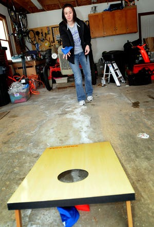 Stefanie Weiss / The Journal-Standard
Melissa Golz of Freeport practices for her corn hole game fundraiser benefitting Relay For Life Tuesday.