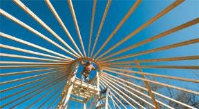 CHIEFTAIN PHOTO/MIKE SWEENEY — Tom Tabeling checks the bolts on the center ring of a yurt being erected at the Pueblo Nature and Raptor Center on Friday.