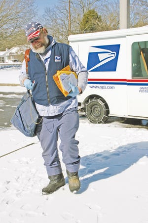 The Oak Ridger’s staff photographer Scott Fraker snapped this photo of Paul Martin of the U.S. Postal Service in Oak Ridge delivering mail in the snow Monday. Martin has worked for the post office for 23 years.