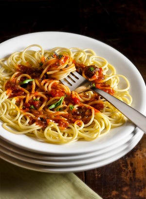 Cooks employ secret ingredients such as the prunes in this spicy tomato sauce to add wow to a meal.