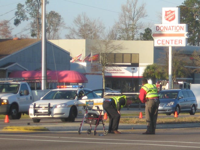 DANA TREEN/The Times-UnionWestbound lanes of Beach Boulevard near St. Johns Bluff Road were closed this morning after a woman using a wheeled walker was hit and killed crossing the road about 6 a.m. Investigators inspect the walker.