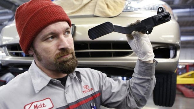 Mechanic Matthew Lee holds a recalled Toyota gas pedal at a Toyota dealership in Palo Alto, Calif., Wednesday, Feb. 3, 2010.