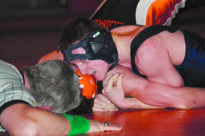 Chris Vogt/Gatehouse news service
Monmouth-Roseville freshman Jake Brooks waits for the call seconds before pinning Macomb's Jacob Moon during their 130-pound bout Tuesday night at Macomb.