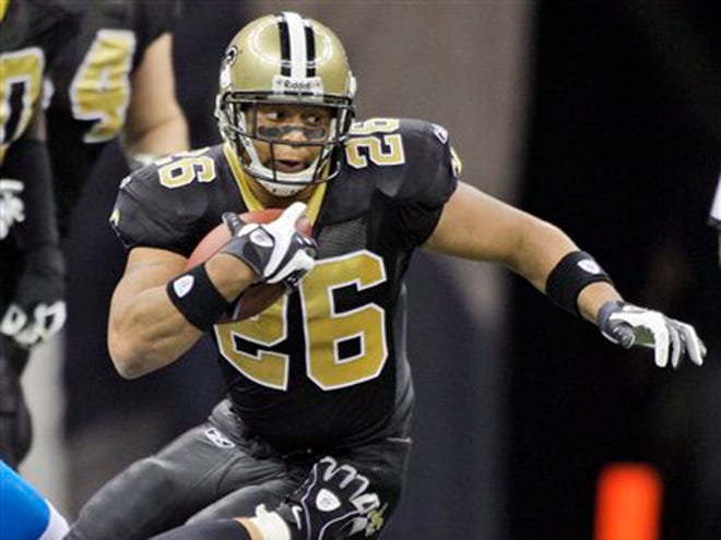 In a Dec. 26, 2008 file photo New Orleans Saints running back Deuce McAllister gets away a Carolina Panthers defender in the first half of their NFL football game in the Superdome in New Orleans.