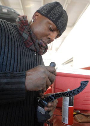 Winston Atkins removes the accelerator assembly from a Toyota Corolla so he can add the precision cut steel reinforcement bar Wednesday afternoon at Chatham Parkway Toyota. Richard Burkhart/Savannah Morning News