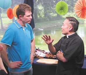 Father Leo Patalinghug chats with Food Network star Bobby Flay at their ‘Throwdown’ at Mount St. Mary’s Seminary in Emmitsburg, where he is a member of the faculty. Patalinghug won with his recipe for fusion steak fajitas.