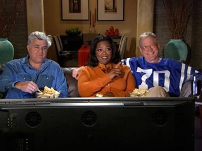 In an image from video provided by CBS, David Letterman, Oprah Winfrey and Jay Leno, from right, record a promo for CBS' "Late Show" that aired during the broadcast of the NFL football Super Bowl on Sunday.