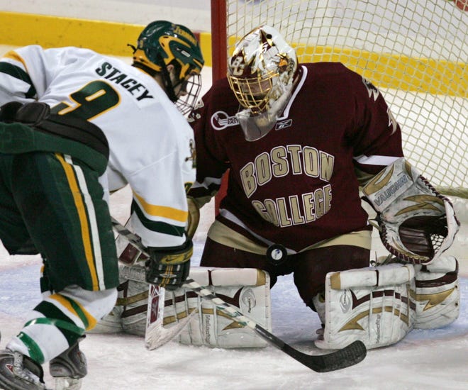 Boston College goaltender John Muse (1) makes a save on a scoring attempt by Vermont's Wahsontiio Stacey (9) during the third period of the Hockey East championship, Saturday, March 22, 2008, in Boston. Boston College won, 4-0. (AP Photo/Mary Schwalm)