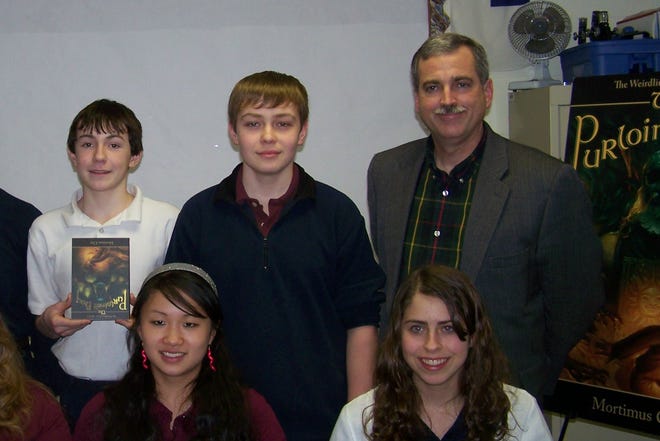 Mortimus Clay visits with some of eighth grade students at Mullein Hill Christian Academy: (back L to R): Garett Holmes, Jr., Noah Kidney, author Mortimus Clay, (front L to R): Shelby Densman and Tori Costa.