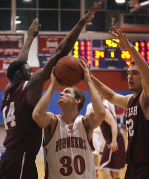 Walsh's Ricky Jackson, left, and Kyelce Cescato, right, guard Jock Rottman in the first half.