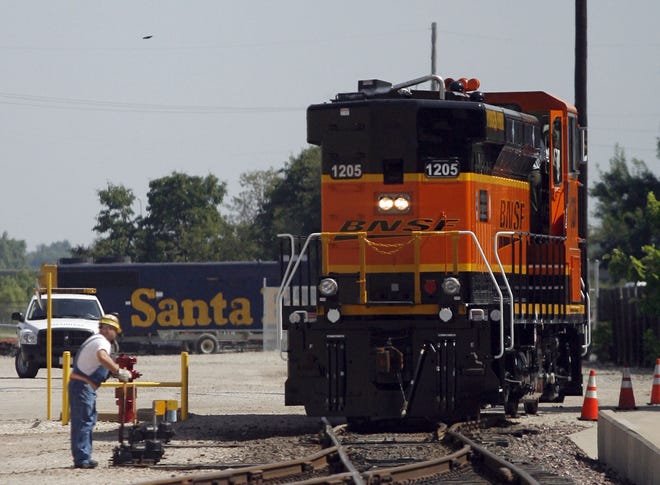 Seventy percent of Burlington Northern Santa Fe shareholders approved the sale of the railroad to Berkshire Hathaway, BNSF announced Thursday. The Omaha, Neb.-based business is owned by billionaire Warren Buffett. Groundsman Shawn Semple is shown here switching the tracks at the BNSF shops in Topeka.