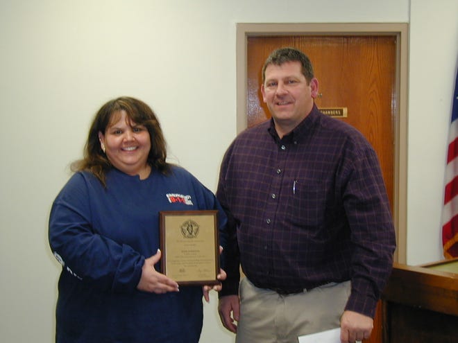 Rose Juergens is congratulated by Fulton County Sheriff Jeff Standard for being chosen the Illinois Sheriff's Association Telecommunicator of the Year for 2009. Juergens was recognized during the regular February meeting of the Fulton County Board.