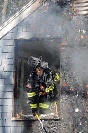 Firefighters from five towns battled a two-alarm fire Thursday at 18 Wellesley Street in Weston.