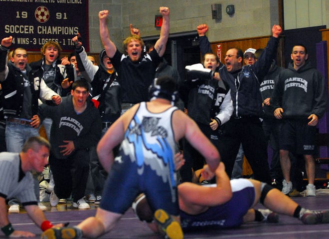The Franklin bench erupts after Mike Gill (foreground) pinned his opponent to close out the Panthers' 48-18 win over Shawsheen Tech in the Division 1 state semifinals.