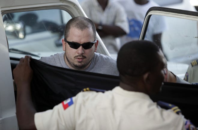 Topekan Drew Culberth exits a Haitian police truck after being taken back to jail in Port-au-Prince after a hearing on Feb. 4. He is one of the 10 detained Americans awaiting word on a prosecutor's response to a judge's ruling on Thursday to grant the missionaries a provisional release.