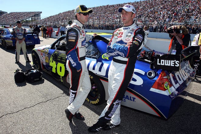 Jimmie Johnson, driver of the #48 Lowe's Chevrolet talks with crew chief Chad Knaus (R) on the grid prior to the start of the NASCAR Sprint Cup Series Sylvania 300 at the New Hampshire Motor Speedway on Sept. 20, 2009 in Loudon, New Hampshire. (Photo by Jim McIsaac/Getty Images for NASCAR)