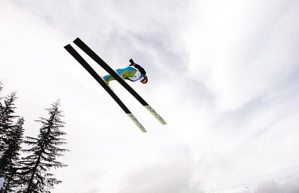 Switzerland's Simon Ammann during the ski jumping normal hill qualification at the Vancouver 2010 Olympics in Whistler, British Columbia, Canada, Friday, Feb. 12, 2010. (AP Photo/Matthias Schrader)