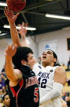 Knox College freshman Lukas Shaw goes for a lay-up with pressure from Lake Forest defender Patrick Hanley during the first half Saturday afternoon in Memorial Gymnasium.