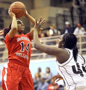 McKinley's Ameryst Alston shoots the ball over Boardman's Darryce Moore during Saturday's Federal League high school girls basketball tournament championship. Alston scored 20 points in the Bulldogs' 54-49 win.