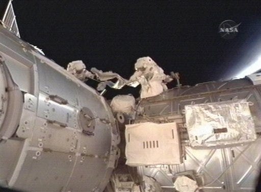 This Feb. 13, 2010 file image taken from video and made available by NASA shows astronauts Robert Behnken and Nicholas Patrick during their spacewalk as they work outside the International Space Station.