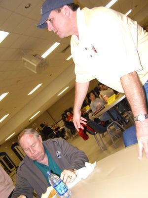 Dixie World Series Committee chairman Gregg Patterson speaks with Loyson Porta during a meeting Feb. 9 at the Gonzales Civic Center. The committee is seeking additional volunteers.