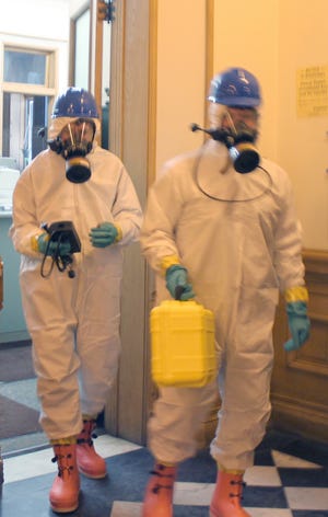Members of the Ionia Public Safety Hazmat team clear the Ionia County Clerk’s Office Wednesday after determining the white powder mailed to the clerk was not dangerous.