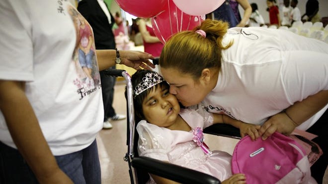 Gisselle Gonzalez is kissed by her aunt Norma Venegas on Gisselle Gonzalez Day at Belle Glade Elementary.