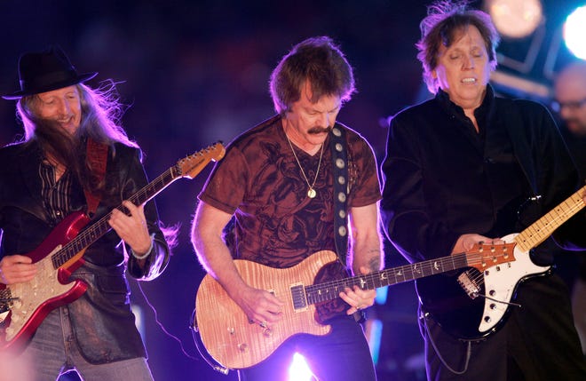 Members of The Doobie Brothers, from left to right, Patrick Simmons, Tom Johnston, and John McFee perform during halftime of the Orange Bowl NCAA college football game in Miami in this Jan. 1, 2009 file photo.