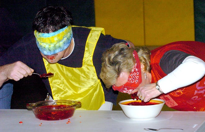 Jeff Clemens, custodian and Margie McDougal principal of Greentown School participate in a Jell-O eating contest during "Let the Games Begin" held Friday. The Staff Olympics included a licorice eating contest, chair passing contest, bobbing for marshmallows and more.