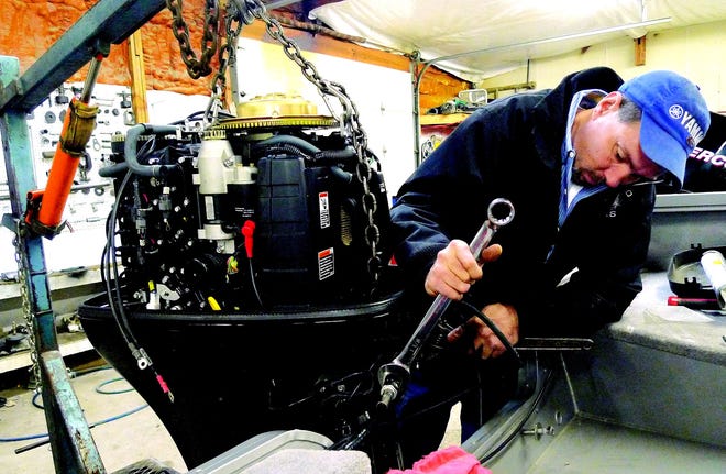 Mechanic Fred Rutherford installs an outboard motor at East Side Marine on Wednesday. Boat dealers are preparing for annual Boat Show in Springfield at the Illinois State Fairgrounds, Feb. 26-28. The boat show typically kicks off the boating season.