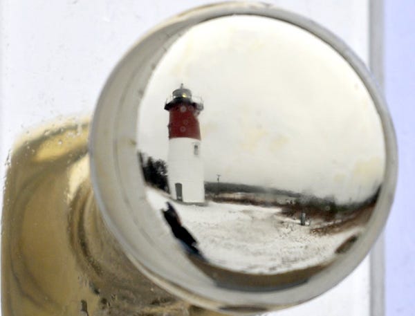 The brass doorknob of the oil house at Nauset Light in North Eastham reflects a gloomy day on the Lower Cape last week.