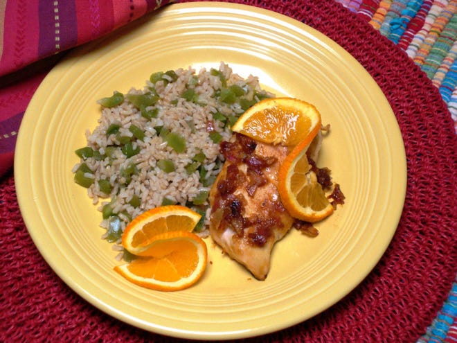 Chicken sauteed in a savory orange sauce is an unusual, tangy Mexican dish. Rice tossed with green peppers makes a simple side dish. (MCT)