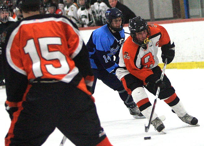 Oliver Ames' Billy Podoleski brings the puck up the ice in Saturday's all-star game in Canton. The Tigers will be hosting Dedham in the first round of the Division 2 South Monday at 8 p.m. at the Asiaf Rink in Brockton.