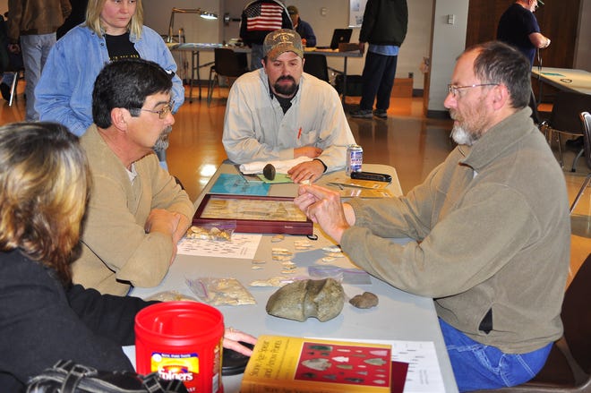 Museum director Michael Wiant (at right), and below right, museum archaeologist Alan Harn (seated), offer their insight on artifacts, including a large number of arrowheads brought in during the event.
