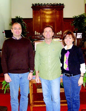 Randy Mosher, left, pastor of Calvary Chapel Cumberland Valley, handed over the keys of the church at 145 E. Baltimore St., to Dave and Cathy Pence, pastors of The New Life Center, after a joint service Feb. 21. Both congregations started by meeting at the Rescue Hose Company. CCCV rented the church building from 2002 to 2010. They just relocated to Hagerstown and TLC moved into the vacated space.