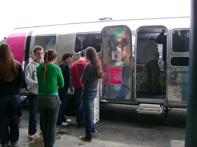 Students gather outside of the Airstream that houses innovative product designs at one of the stops on the Design Revolution Road Show. The show will stop in Savannah on Saturday. (Courtesy of Project H Design)
