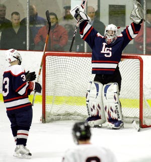 Lincoln-Sudbury's goalie #30 Jack Burke raises his arms in celebration after time runs out in Tuesday night's 2-1 win over North Andover at the Ryan Skating Rink in Watertown.