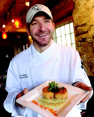Chef Noah Jaques shows off his Cakes of Crab at Cork.