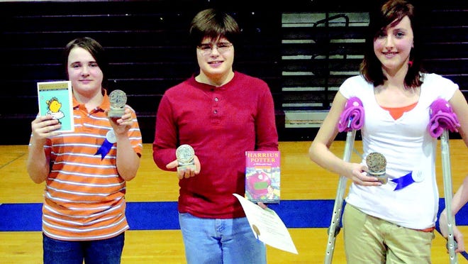 Nathan Daw (middle), an eighth grader of Mrs. Heaton at Monmouth-Roseville Junior High School, took home first place, fellow classmate Sean Paulsgrove took second and Emma Willhardt, a seventh grader of Mrs. Thomas at Monmouth-Roseville Junior High School, took home third at the 11th annual Classics Bee Tuesday night.