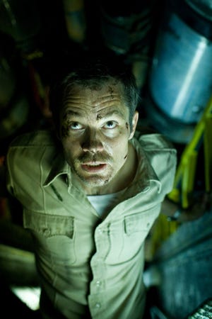 In this film publicity image released by Overture Films, Timothy Olyphant is shown in a scene from "The Crazies."