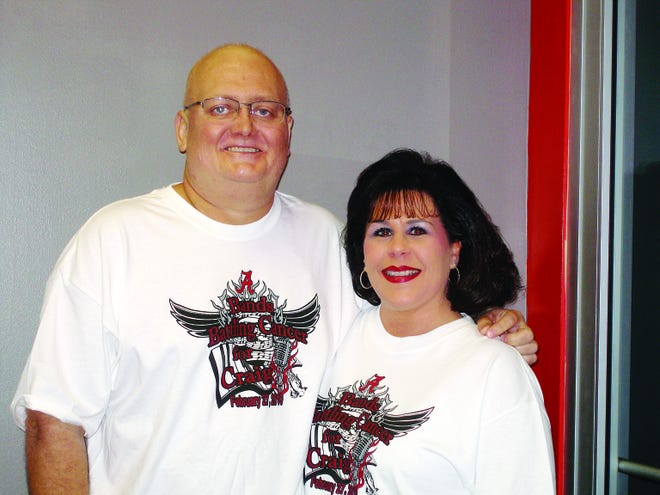 Craig and Melodie Osborn pose Monday at Absolute Fitness in Rainbow City in the T-shirts being sold to help pay for Craig's fight against non-small cell lung cancer. There is also a concert Saturday to help the Osborn's with his medical bills. Bands Battling Cancer for Craig will begin at 8 p.m. at Center Stage in Rainbow City.