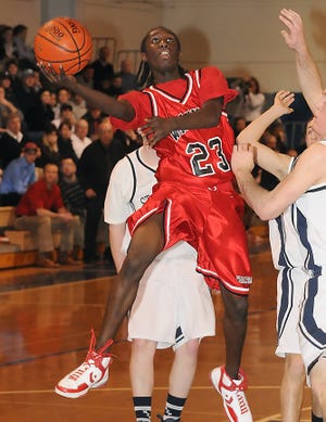 Waltham senior A.J. Prince drives to the basket during last night's 70-55 loss to St. John's Prep in the first round of the Division 1 North tourney.